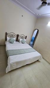 a bedroom with two beds and a window at Value Stays By Amisha Palace in Jaipur