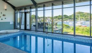 a swimming pool with a view of a marina at Otterpoint Waterfront & Pool Retreat in Tayvallich