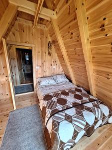 a bedroom with a bed in a log cabin at Koliba SAN in Žabljak