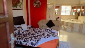 a bedroom with a bed and a bathroom with a sink at Mizpah Self Catering Accommodation in Walvis Bay +35 photos