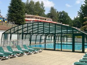 a building with chairs and a pool with a train at SAS Le Bataillet in Montégut