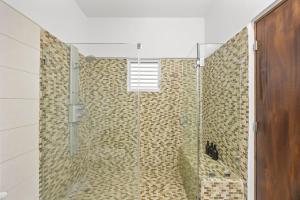 a shower with a glass door in a bathroom at Casa Lotus in San Juan +35 photos
