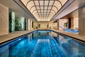 an indoor swimming pool with a domed ceiling at The Landmark London in London