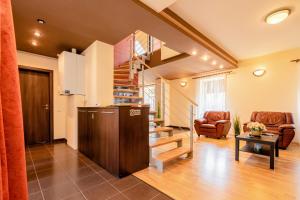 a living room with a staircase in a house at CROSS SQUARE HOUSE - Spacious 2 Level Home, 2BR, 3Baths, Terrace - by RealTrust in Timişoara