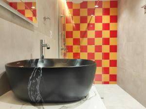 a black bath tub sitting on a counter in a bathroom at CORFU INDUSTRIAL Studios in Corfu