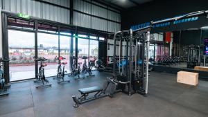 a gym with cardio equipment in a building at 1 bedroom unit with a sunrise view in Tatu City