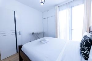 a bedroom with a white bed with a window at 1 bedroom unit with a sunrise view in Tatu City +17 photos