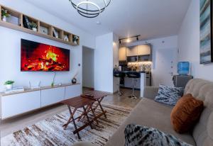 a living room with a couch and a fireplace at 1 bedroom unit with a sunrise view in Tatu City