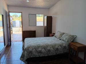 a bedroom with a bed and a door to a patio at Pousada Fernandes in Três Corações +30 photos