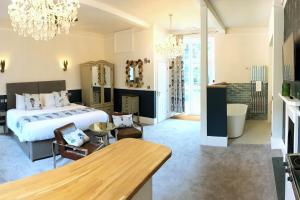 a bedroom with a large bed and a dining room at Fox & Hounds Country Hotel in Chulmleigh