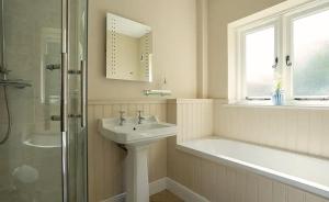 a bathroom with a sink and a shower and a tub at Bluebell in Edlington +10 photos