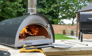 a pizza oven sitting on a table next to a grill at Bluebell in Edlington