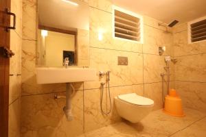 a bathroom with a sink and a toilet at Princess Bungalow Stay Madurai in Tirupparangunram