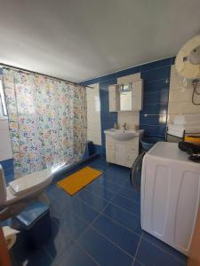 a blue bathroom with a sink and a toilet at Marialena's houses in Methoni +92 photos