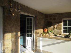 a hallway with a door and a stone wall at Hotel Solar da Capela in Termas de Sao Pedro do Sul