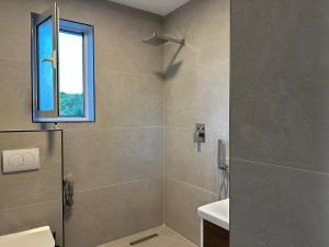 a bathroom with a shower with a glass door at Mosaic Guesthouse in Lin +70 photos