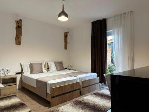 a bedroom with a bed and a television in it at Mosaic Guesthouse in Lin