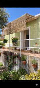 a house with potted plants on the side of it at Pupi Catania Etna Farm in Catania +18 photos