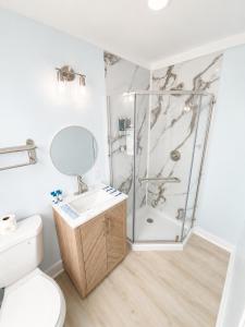a bathroom with a shower and a toilet at The Linda Grande Hotel in Ocean City +20 photos