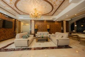 a living room with two couches and a chandelier at Qasr Arin Aprtments For Serviced Apartments شقق قصر ارين للشقق المخدومة in Jeddah