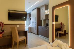a living room with a kitchen and a dining room at The Reserve by Vulcano in Mirto