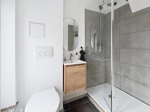 a bathroom with a shower with a toilet and a sink at Third Corner in Liège