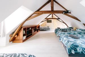 a room with four beds in a attic at L'Antre-neuf - 9p, piscine, arrivée autonome, wifi in Fontaine-Milon +19 photos