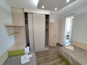 a bedroom with a bed and a large window at Charming Apartment with balcony in Vidin