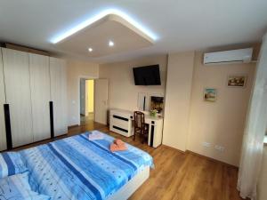 a bedroom with a large bed and a desk at Charming Apartment with balcony in Vidin