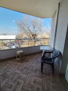 a balcony with a table and a chair on a building at Charming Apartment with balcony in Vidin