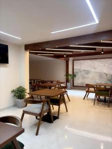 a room with wooden tables and chairs and a window at Casa Herrerías Hotel & Confort in Cuenca