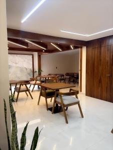 a room with wooden tables and chairs in it at Casa Herrerías Hotel & Confort in Cuenca