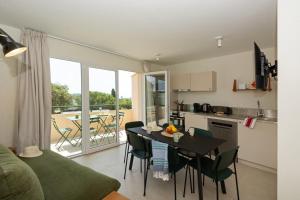 a kitchen and dining room with a table and chairs at Versants - La Croix Valmer in La Croix-Valmer +13 photos