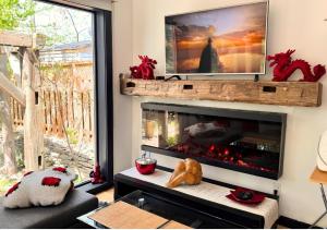 a living room with a fireplace with a tv above it at Peterborough Zen Retreat in Peterborough +24 photos