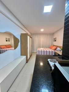 a hotel room with two beds and a television at WestFit - Barreto - 709 in Mossoró +16 photos