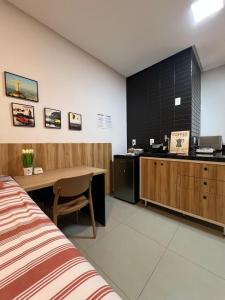 a hotel room with a bed and a desk and a bed at WestFit - Barreto - 709 in Mossoró