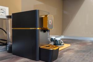 a small black refrigerator sitting on top of a counter at The Reserve by Vulcano in Mirto