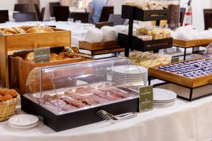 a buffet of pastries and breads on a table at Hotel La Costiera in Varcaturo