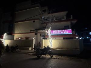a group of motorcycles parked outside of a building at night at Hotel Golden Pearl in Rewa
