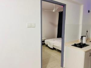 a mirror in a room with a bed and a bedroom at Twice Apartment in Hulhumale