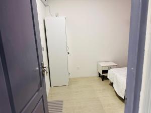 a room with a bed and a door to a bedroom at Twice Apartment in Hulhumale