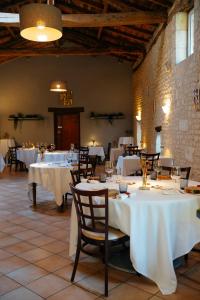 a dining room with tables with white tablecloths at Logis Insolites et Restaurant Domaine du Seudre in Saint-Germain-du-Seudre +42 photos