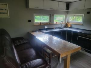 a kitchen with a wooden table and a sink at Забрус насолоди in Kosiv