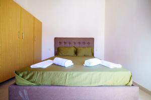 a bedroom with a bed with two towels on it at Sagiada Anchor House in Sagiada