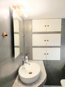 a bathroom with a sink and a mirror at Annousio 's house in Dhriopís