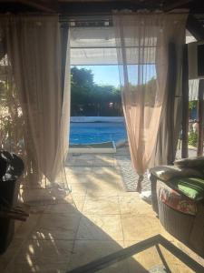 an open door to a patio with a view of the water at Les Poiriers Rouges in Mauchamps