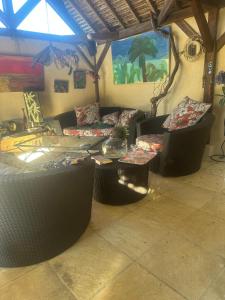 a living room with couches and a table in a room at Les Poiriers Rouges in Mauchamps