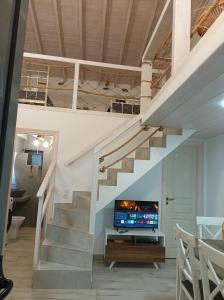 a staircase leading up to a living room with a tv at Annousio 's house in Dhriopís