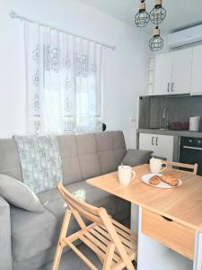 a living room with a table and a couch at Annousio 's house in Dhriopís +32 photos