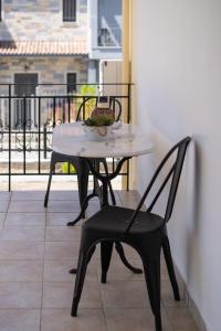 a table and a chair on a balcony at Sagiada Anchor House in Sagiada